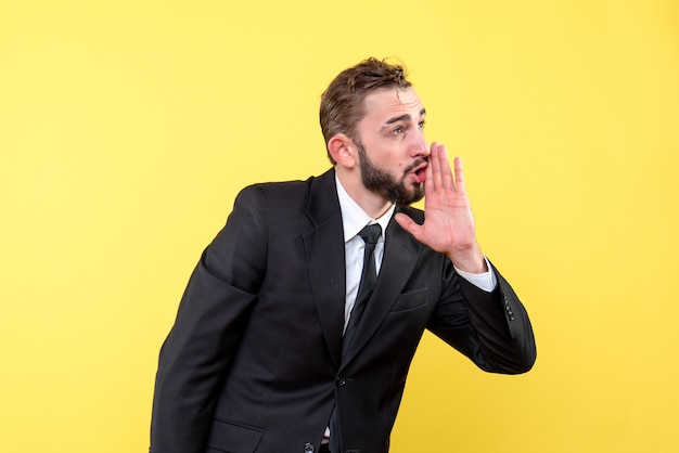 Front view of young man businessman prompts on yellow