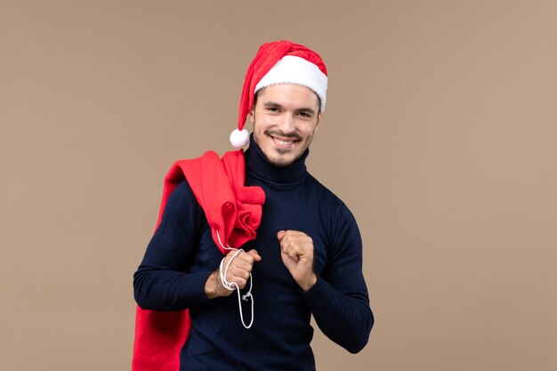 Front view young man carrying present bag, christmas holiday santa