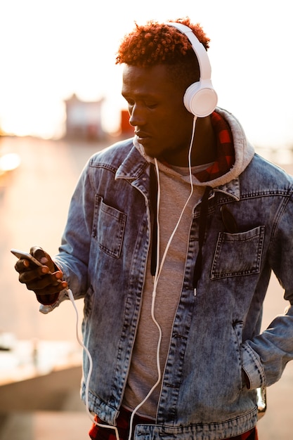 Front view young man checking music playlist