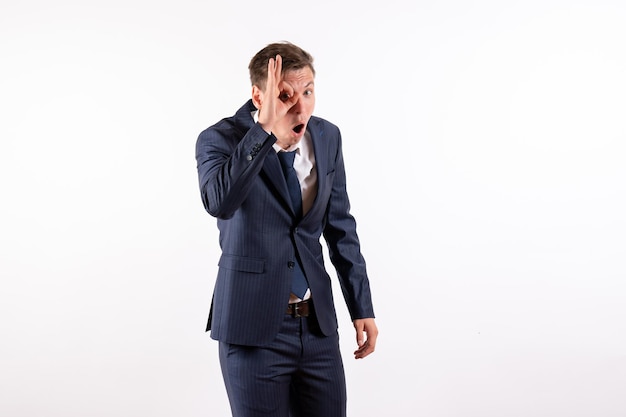 Front view young man in elegant classic suit posing on white background