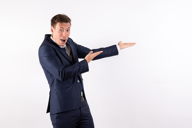 Front view young man in elegant classic suit posing on white background