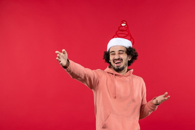 Front view of young man just laughing on the red wall