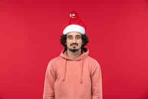 Free photo front view of young man just standing on red wall