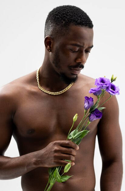 Front view young man posing with flowers