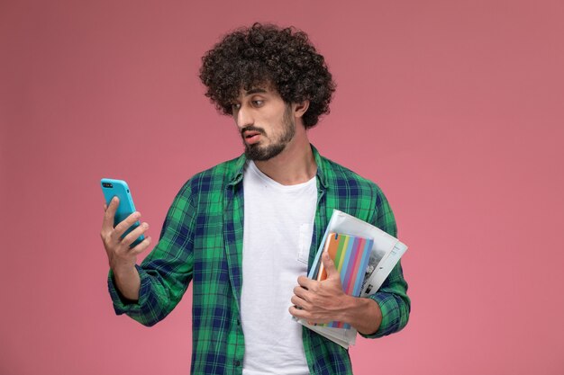 Front view young man sees weird news on phone