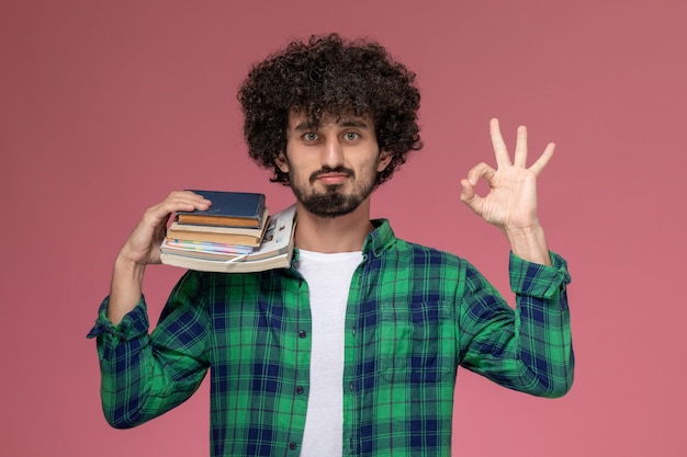 Free photo front view young man shows well done gesture