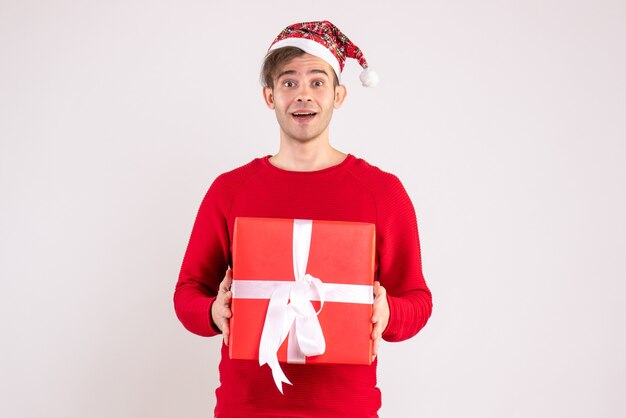 Front view young man sitting around xmas gifts copy space