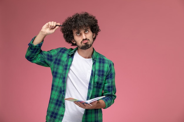 Free photo front view young man tries to solve math problem