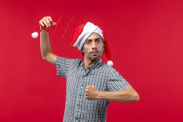 Free photo front view of young man with angry expression on red wall