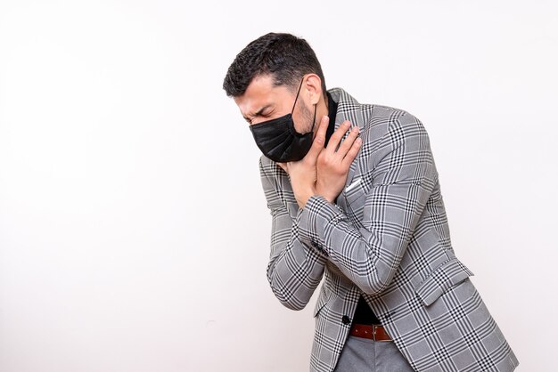 Front view young man with black mask holding throat standing on white isolated background