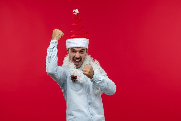Front View of Young Man with Excited Expression on Red Wall