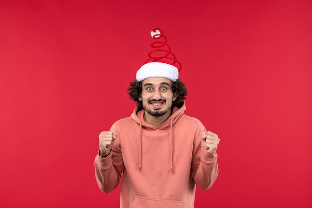 Free photo front view of young man with happy expression on red wall