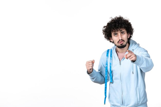 Front view young man with measure tape on white background health muscle body torso measuring losing weight human slimming