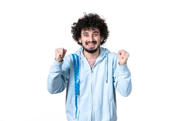 Front view young man with measure tape on white surface