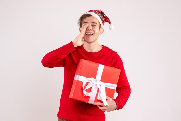 Front view young man with santa hat calling someone on white background
