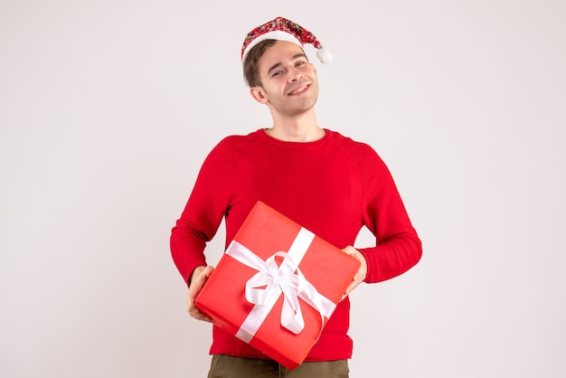 Front view young man with santa hat standing on white background free space