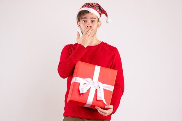 Front view young man with santa hat standing on white background free space