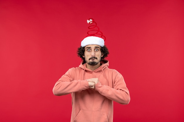 Free photo front view of young man with scared expression on red wall