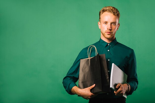 Front view young man with shopping bags