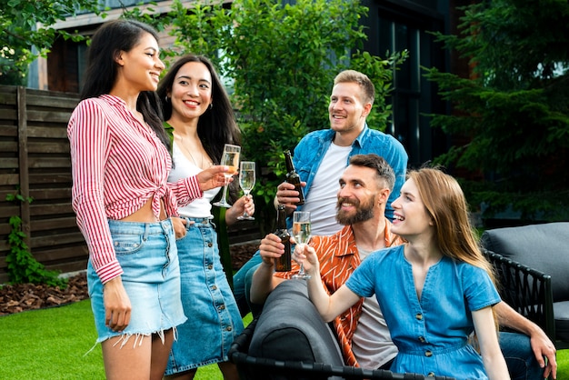 Front view young people toasting drinks