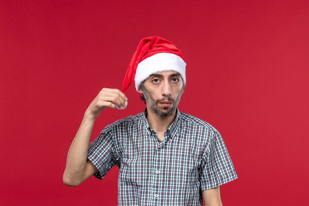 Front view young person with new year cap on red wall new year red holidays