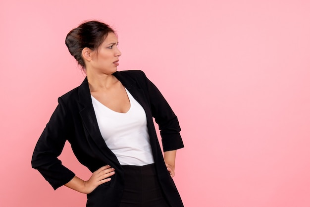 Front view young pretty female in dark jacket on pink background