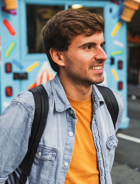 Front view young smiley man in city