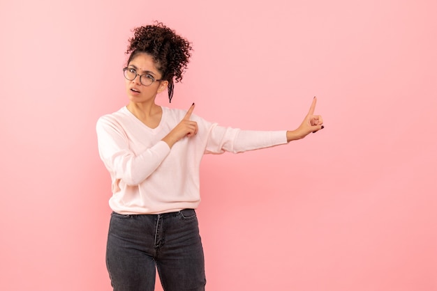 Free photo front view of young woman angry on pink wall