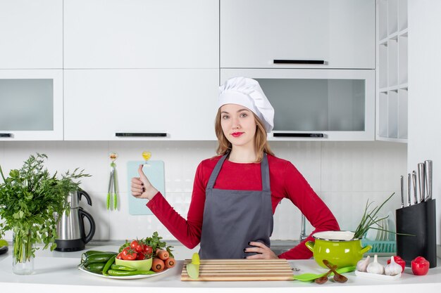 Front view young woman in apron giving thumbs up