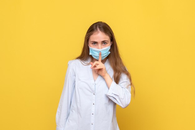 Front view of young woman asking to be silent