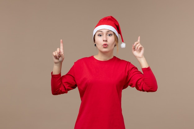 Front view of young woman on brown