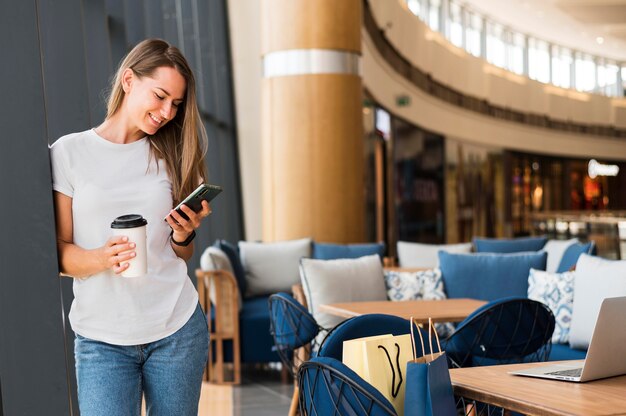 Front view young woman browsing mobile phone