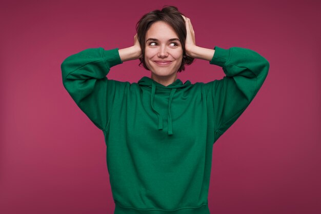 Front view of a young woman covering her ears