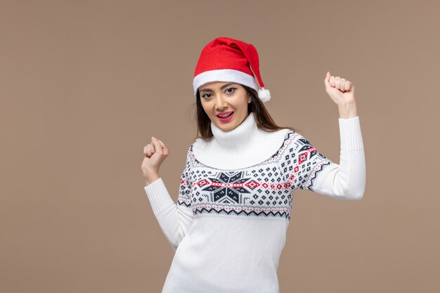 Front view young woman dancing on brown background christmas new year emotion