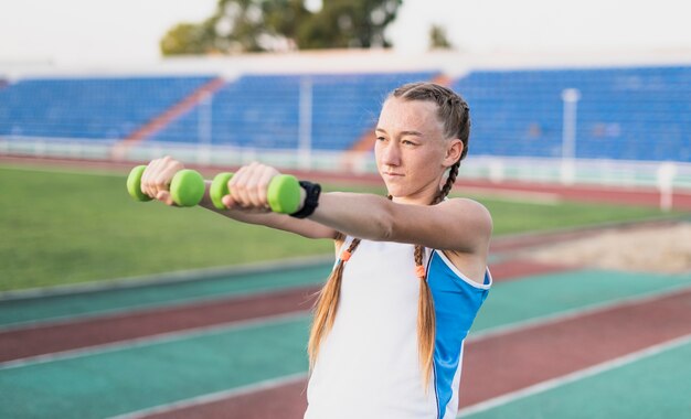 Front view young woman doing hands exercise