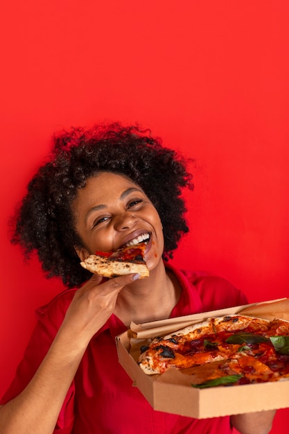 Free photo front view young woman eating delicious pizza