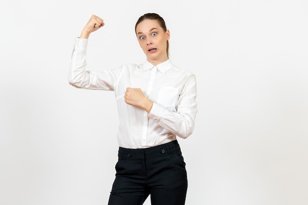Front view young woman in elegant white blouse flexing on white background woman office job lady female worker