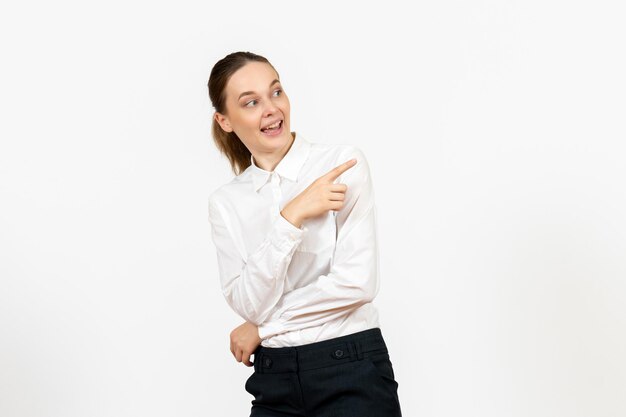 Front view young woman in elegant white blouse just standing on a white background woman office job female worker lady