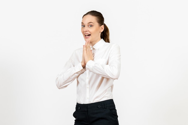 Front view young woman in elegant white blouse just standing on the white background woman office job female worker lady