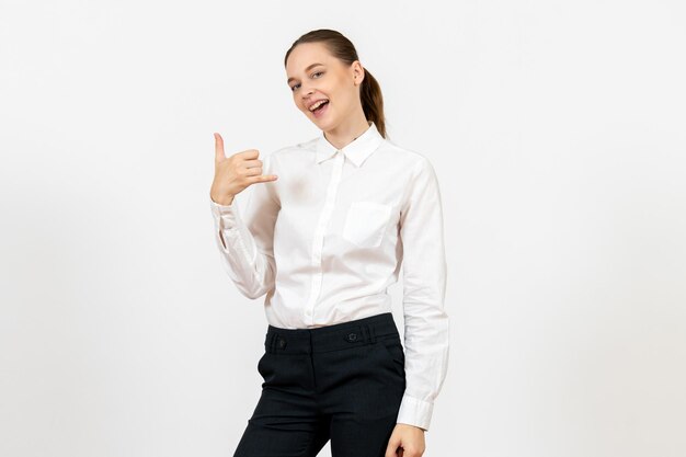 Front view young woman in elegant white blouse posing on white background woman office job lady female worker