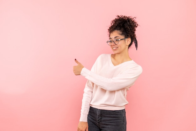 Free photo front view of young woman excited on a pink wall