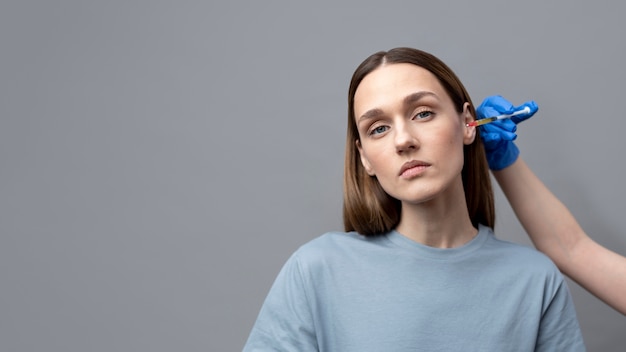 Free photo front view young woman getting prp injection