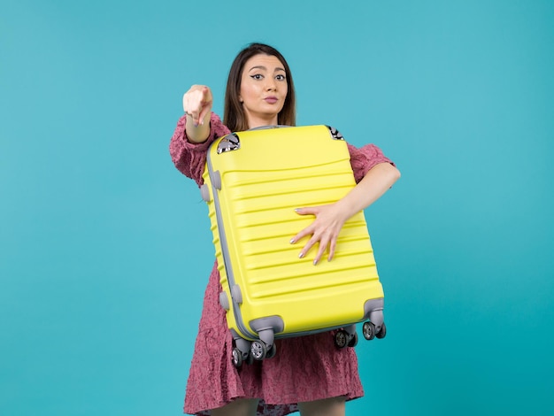 Front view young woman going in vacation and holding big bag on blue background journey sea vacation voyage woman