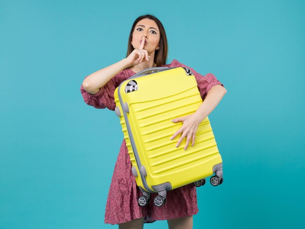 Front view young woman going in vacation and holding big bag on blue background journey vacation voyage woman sea abroad