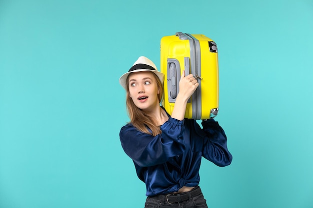 Front view young woman going in vacation and holding big bag on blue desk travel sea journey vacation voyage