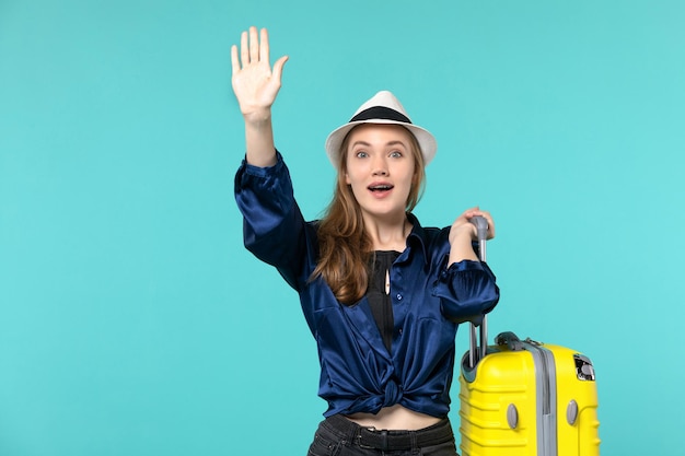 Front view young woman going in vacation and holding big bag on blue floor travel sea girl journey vacation voyage