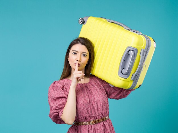 Front view young woman going in vacation with her big bag on blue background summer journey woman sea vacation voyage