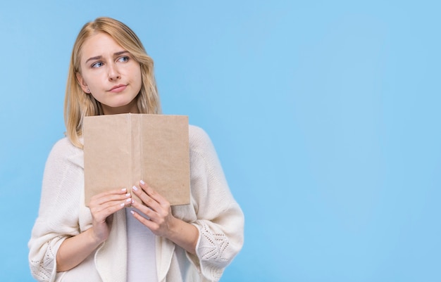 Front view young woman holding a book