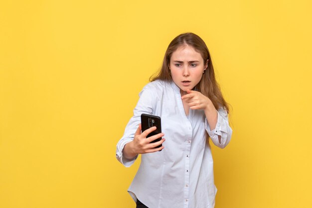 Front view of young woman holding phone