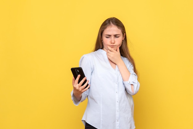 Front view of young woman holding phone